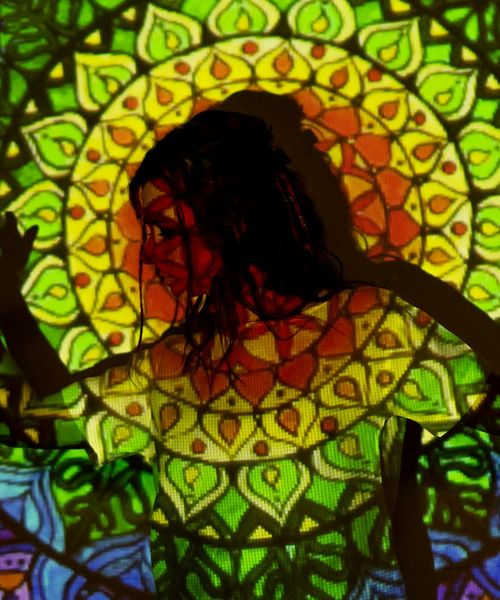 Silhouette of a person in a powerful yoga pose against a light purple background.